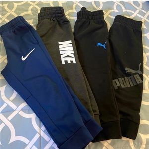 Two Nike and two puma boys pants